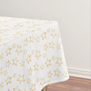 Glittering Golden Star Silhouettes on White Tablecloth