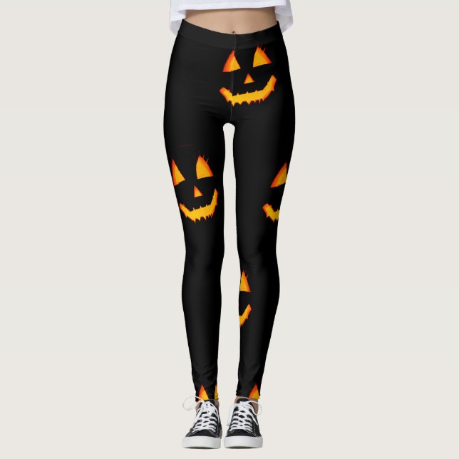 Glowing jack-o-lattern face on black halloween leggings (Front)