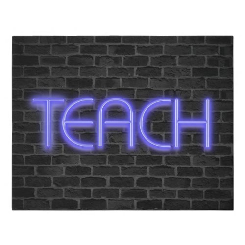 glowing neon TEACH sign on brick