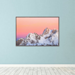 Glowing sunset sky and snowy mountains canvas print