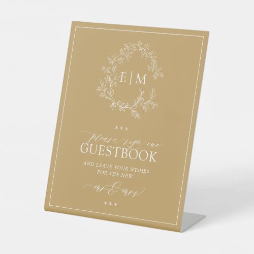 Go;d Leafy Crest Monogram Wedding Guestbook Pedest Pedestal Sign - We're loving this trendy, modern gold wedding guestbook pedestal sign! Simple, elegant, and oh-so-pretty, it features a hand drawn leafy wreath encircling a modern wedding monogram. It is personalized in elegant typography, and accented with hand-lettered calligraphy. Finally, it is trimmed in a delicate frame. Veiw suite here: https://www.zazzle.com/collections/gold_leafy_crest_monogram_wedding-119668631605460589 Contact designer for matching products to complete the suite, OR for color variations of this design. Thank you sooo much for supporting our small business, we really appreciate it! 
We are so happy you love this design as much as we do, and would love to invite
you to be part of our new private Facebook group Wedding Planning Tips for Busy Brides. 
Join to receive the latest on sales, new releases and more! 
https://www.facebook.com/groups/622298402544171  
Copyright Anastasia Surridge for Elegant Invites, all rights reserved.