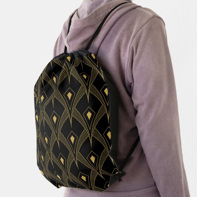 Gol art deco pattern on black drawstring bag (Insitu)