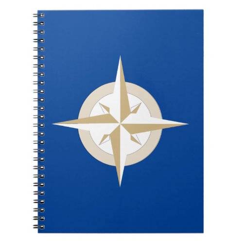 Gold and White Compass on Blue Field Notebook