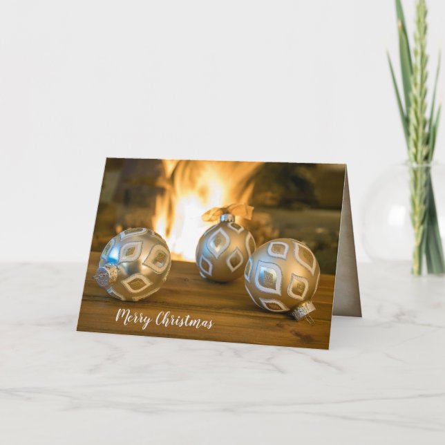gold Christmas ornaments by fireplace Holiday Card (Front)