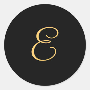 Gold-colored initial E on black monogram  round Classic Round Sticker