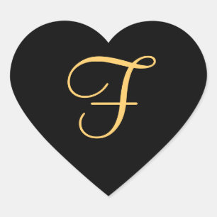 Gold-colored initial f on black background, heart sticker