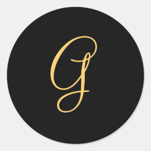 Gold-colored initial G on black monogram round Classic Round Sticker