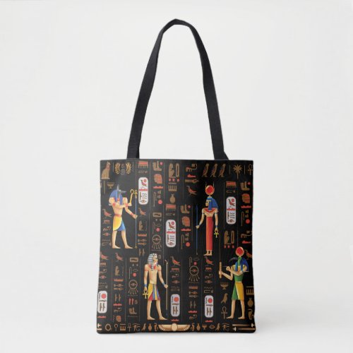 Gold Egyptian hieroglyphs and deities on black Tote Bag