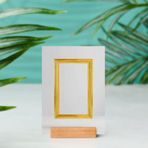 gold framed picture is on a gray wall