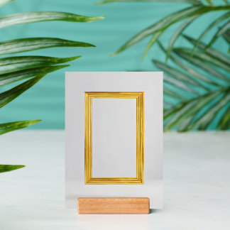 gold framed picture is on a gray wall holder