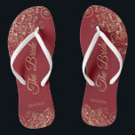 Gold Frills Crimson Red Elegant The Bride Wedding Flip Flops<br><div class="desc">Dance the night away with these beautiful wedding flip flops. Designed for the bride, they feature a simple yet elegant design with gold colored script lettering on a crimson red background and fancy golden lace curls and swirls. Beautiful way to stay fancy and appropriate while giving your feet a break...</div>