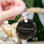 Gold Frills on Black Bridesmaid Wedding Gift Keychain<br><div class="desc">These keychains are designed to give as favors to bridesmaids in your wedding party. They feature a simple yet elegant design with a classic black background, gold script lettering, and a lacy golden faux foil floral border. The text says "Bridesmaid" with space for her name, the names of the couple,...</div>