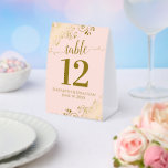 Gold Frills on Blush Pink Wedding Table Number Paper Table Tent<br><div class="desc">These beautiful table tent signs will make it easy for your guests to find their tables at your wedding reception. The elegant pale blush pink and gold design features lacy script calligraphy with ornate floral curls and swirls in the corners. There is space for the names of the couple and...</div>