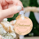 Gold Frills on Coral Peach Bridesmaid Wedding Gift Keychain<br><div class="desc">These keychains are designed to give as favors to bridesmaids in your wedding party. They feature a simple yet elegant design with a pale coral peach or light orange colored background, gold script lettering, and a lacy golden faux foil floral border. The text says "Bridesmaid" with space for her name,...</div>