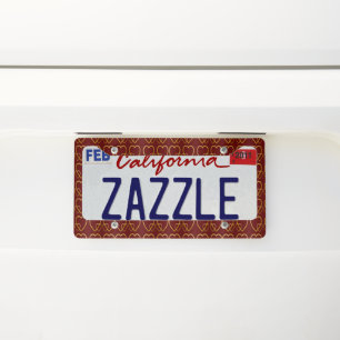 Gold hearts on maroon license plate frame