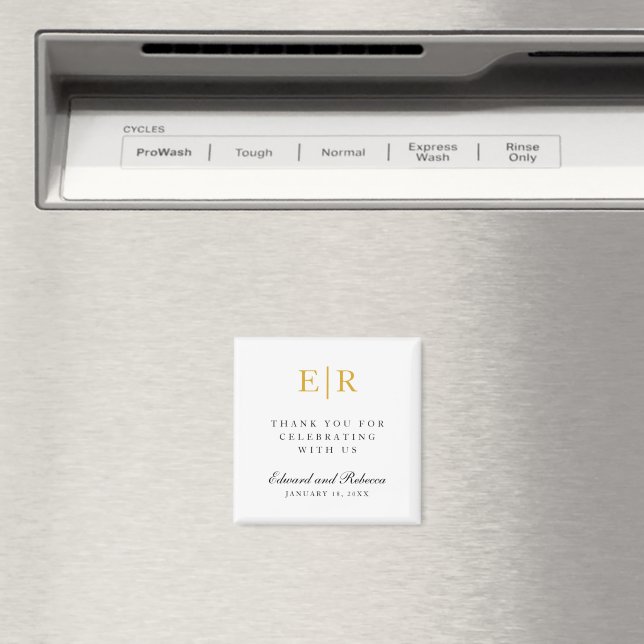 A white custom initial magnet displayed on a silver fridge. 



