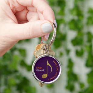 gold musical note on purple keychain with name