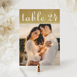 Gold Shimmer Wedding Photo Table Number<br><div class="desc">Elegant custom wedding table cards can be personalized with an engagement photo of the bride and groom. Design features white modern script table number text on a shimmery faux fold foil background. To customize: type in the table number, click "change" by the default photo to upload your own photo, and...</div>
