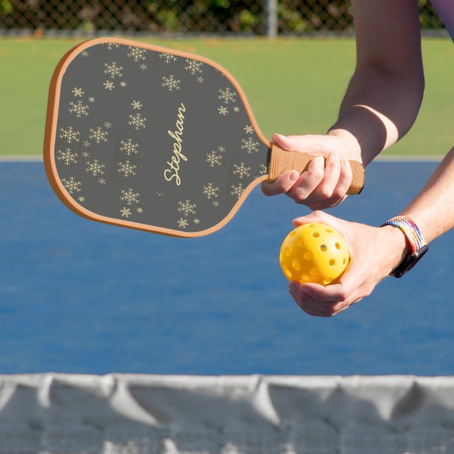 Gold snowflakes on gray pickleball paddle (Insitu)