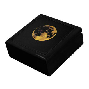 Gold textured moon on dark black gift box