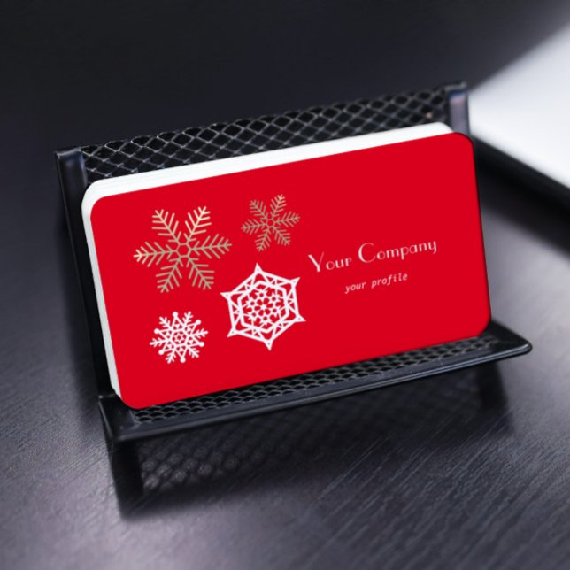 golden and white snowflakes against red business card (Creator Uploaded)