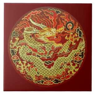Golden asian dragon embroidered on dark red ceramic tile