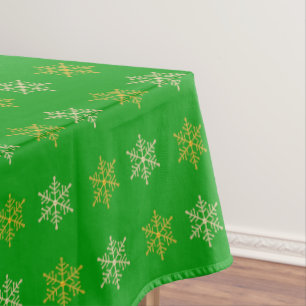 Golden Christmas Snowflakes on Green Tablecloth