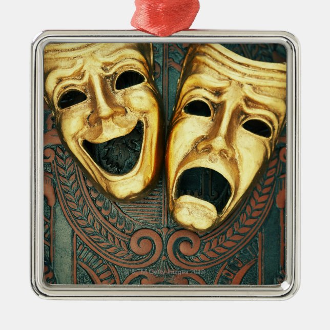 Golden comedy and tragedy masks on patterned metal ornament (Front)