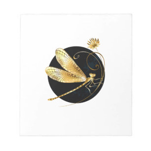 Golden dragonfly in black circle notepad