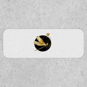 Golden dragonfly in black circle patch
