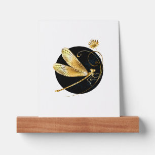 Golden dragonfly in black circle picture ledge