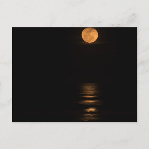 golden full moon over ocean postcard