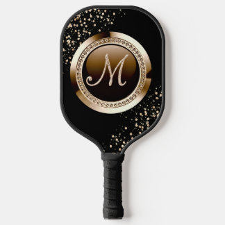 golden glitter letter and black pickleball paddle