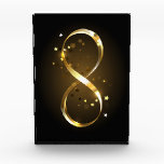 Golden Infinity Symbol Acrylic Award<br><div class="desc">Gold, jewelry infinity symbol with gold stars on a black background. Design with gold star.</div>