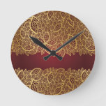 Golden leaf lace on red background round clock