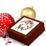 Golden Reindeer Christmas Gift Box<br><div class="desc">This Christmas gift box features a golden reindeer, surrounded by a wreath of gold stars and holly, with a large red ribbon. This festive gift box would also be great for Christmas entertaining (to put nibbles in, such as nuts for example), extra storage for Christmas or just as a Christmas...</div>