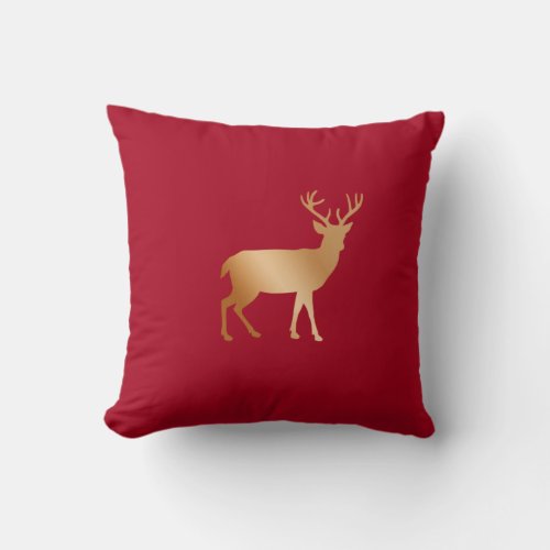 Golden reindeer silhouette on burgundy red throw pillow