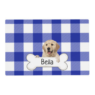 golden retriever with bone on blue plaid placemat