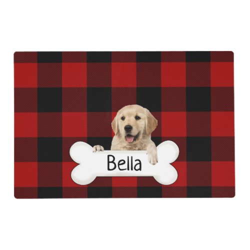 Golden retriever with bone on plaid placemat