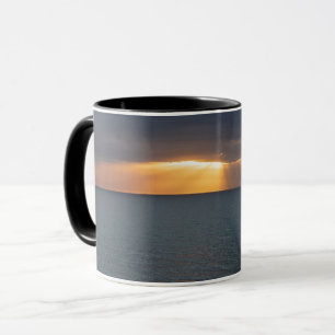 Golden sunset rays over the ocean reflections mug