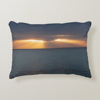 Golden sunset rays over the ocean with reflections