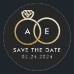 Golden Wedding Rings on Black Save the Date Classic Round Sticker<br><div class="desc">A modern monogram gets glam with intertwined golden wedding rings on a black background and easy to personalize text for your initials,  wording and the wedding date to be saved.</div>