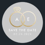 Golden Wedding Rings on Pale Gray Save the Date Classic Round Sticker<br><div class="desc">A modern monogram gets glam with intertwined golden wedding rings on a light,  pale gray background and easy to personalize text for your initials,  wording and the wedding date to be saved.</div>