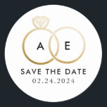 Golden Wedding Rings on White Save the Date Classic Round Sticker<br><div class="desc">A modern monogram gets glam with intertwined golden wedding rings on a white background and easy to personalize black text for your initials,  wording and the wedding date to be saved.</div>