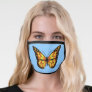 Golden yellow and black butterfly on light blue face mask