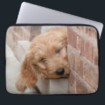Goldendoodle Puppy Peeking Laptop Sleeve<br><div class="desc">An adorable eleven week old Goldendoodle with bright eyes curiously peeks out from a doorway in a brick wall</div>