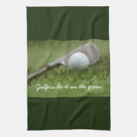 Golf ball and sand wedge golfers do it on green kitchen towel
