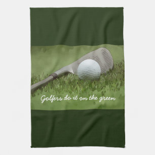 Golf ball and sand wedge golfers do it on green kitchen towel