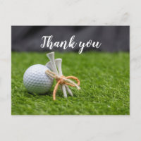Golf ball and tee are on green grass thank you postcard
