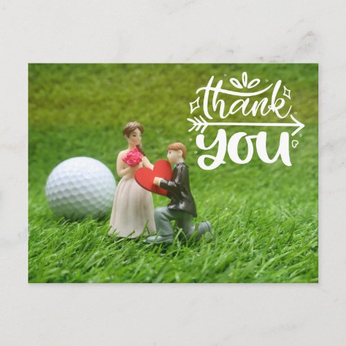 Golf ball and tee are on green grass  Wedding Postcard
